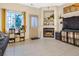 Comfortable living room featuring a fireplace, built-in shelving, and a large window at 2143 Coronado N Pkwy # C, Denver, CO 80229