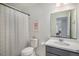 Bathroom with a shower curtain and a modern vanity with a large mirror at 6027 N Netherland Ct, Aurora, CO 80019
