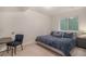 Bedroom featuring a comfortable bed, a desk, and a window providing natural light at 6027 N Netherland Ct, Aurora, CO 80019