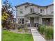 Charming two-story home featuring stone accents, well-manicured landscaping, and a welcoming front porch at 6027 N Netherland Ct, Aurora, CO 80019