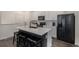 Modern kitchen featuring stainless steel appliances, a large center island, and sleek white cabinets at 6027 N Netherland Ct, Aurora, CO 80019