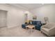 Basement living area with a blue sectional sofa, side chair, and a small coffee table at 6027 N Netherland Ct, Aurora, CO 80019