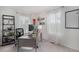 Bright home office with a modern desk, shelving, and a large window with sheer curtains at 6027 N Netherland Ct, Aurora, CO 80019
