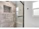 Beautiful bathroom with a large walk in shower that includes updated tile and a built in shower seat at 479 S Kendall St, Lakewood, CO 80226