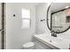 Stylish bathroom featuring a modern vanity and a glass-enclosed shower at 479 S Kendall St, Lakewood, CO 80226