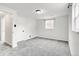 Cozy bedroom featuring neutral carpet, white walls, a window for natural light, and a closet for storage at 479 S Kendall St, Lakewood, CO 80226