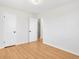 Empty bedroom features hardwood floors, white walls, and a double door closet at 479 S Kendall St, Lakewood, CO 80226