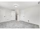 A bedroom with neutral carpet, a closet, and multiple entry ways leading to other rooms at 479 S Kendall St, Lakewood, CO 80226