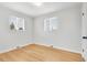 Empty bedroom features hardwood floors, two windows, and white walls at 479 S Kendall St, Lakewood, CO 80226