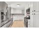 Modern kitchen featuring stainless steel appliances and bright white cabinetry at 479 S Kendall St, Lakewood, CO 80226