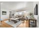 Bright living room with hardwood floors, neutral tones, and a large window view at 479 S Kendall St, Lakewood, CO 80226