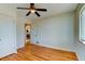 Bedroom featuring hardwood floors, ceiling fan, and a view to the kitchen at 4078 Ames St, Wheat Ridge, CO 80212