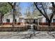 Unique home exterior with symmetrical design, brick accents, wooden fence, and inviting walkway at 4078 Ames St, Wheat Ridge, CO 80212