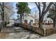 Charming single-story home with a red brick foundation, white siding, and a detached garage in the backyard at 4078 Ames St, Wheat Ridge, CO 80212
