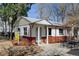 Charming single-story home featuring brick accents, white trim and inviting front patio at 4078 Ames St, Wheat Ridge, CO 80212