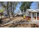 Charming home with a well-maintained front yard and rock landscaping, surrounded by mature trees at 4078 Ames St, Wheat Ridge, CO 80212