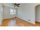 Bright living room with hardwood floors, a ceiling fan, and arched entry to the kitchen at 4078 Ames St, Wheat Ridge, CO 80212