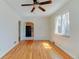 Living room featuring hardwood floors, neutral paint, and an open doorway to the kitchen at 4078 Ames St, Wheat Ridge, CO 80212