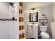 Modern bathroom featuring a tiled shower, white vanity, and decorative shelving at 6333 Zang Ct # E, Arvada, CO 80004