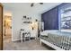 Spacious bedroom with a star-themed accent wall, carpet floors, and a bathroom at 6333 Zang Ct # E, Arvada, CO 80004