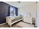Cozy bedroom featuring a unique space-themed accent wall and neutral-toned carpet at 6333 Zang Ct # E, Arvada, CO 80004
