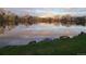 Scenic view of a tranquil lake reflecting the sky and surrounding landscape at sunset at 6333 Zang Ct # E, Arvada, CO 80004