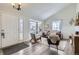 Cozy living room boasting hardwood floors, neutral paint, and a bay window at 6333 Zang Ct # E, Arvada, CO 80004