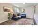 Inviting living room featuring a plush blue sofa, decorative rug, and stylish accents at 6333 Zang Ct # E, Arvada, CO 80004