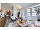 Inviting living area with stylish furniture, a large window, and an open layout for seamless entertaining at 6333 Zang Ct # E, Arvada, CO 80004