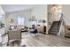 Bright living room features a fireplace, wood floors, and a staircase leading to the upper level at 6333 Zang Ct # E, Arvada, CO 80004