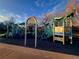 Community playground area with colorful play structures and soft ground surface at 6333 Zang Ct # E, Arvada, CO 80004