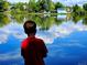 in a red shirt fishing in a pond and surrounded by trees at 6333 Zang Ct # E, Arvada, CO 80004