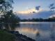 Scenic view of the neighborhood pond at dusk with beautiful reflections of the sky on the water at 6333 Zang Ct # E, Arvada, CO 80004
