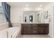 Bright bathroom features double sinks, tiled floors, soaking tub, and modern finishes for a luxurious feel at 154 Back Nine Dr, Castle Pines, CO 80108