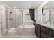 Bright bathroom featuring granite counters, glass enclosed shower, soaking tub, and modern fixtures at 154 Back Nine Dr, Castle Pines, CO 80108