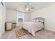 Bright bedroom with natural light, featuring a soft rug, ceiling fan, and plush bedding for a restful ambiance at 154 Back Nine Dr, Castle Pines, CO 80108