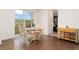 Cozy dining area with wood floors and a view of the backyard, adjacent to the kitchen at 154 Back Nine Dr, Castle Pines, CO 80108