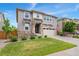 Charming two-story home features well-manicured lawn, neutral siding, stone-accented entryway, and a two-car garage at 154 Back Nine Dr, Castle Pines, CO 80108
