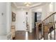Bright foyer boasts hardwood floors, white trim, and staircase leading to the upper level, creating a welcoming entrance at 154 Back Nine Dr, Castle Pines, CO 80108