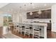 The light-filled kitchen with an island and barstools creates a great space for cooking and entertaining guests at 154 Back Nine Dr, Castle Pines, CO 80108
