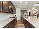 Modern kitchen featuring granite counters, stainless appliances, dark wood cabinets and an eat-in kitchen at 154 Back Nine Dr, Castle Pines, CO 80108