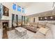 Open floor plan showcasing living room with fireplace, leading into the kitchen and dining area at 154 Back Nine Dr, Castle Pines, CO 80108