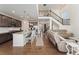 The open-concept living area features a kitchen with an island, flowing into a relaxed living space with hardwood floors at 154 Back Nine Dr, Castle Pines, CO 80108