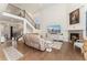 Bright and airy living room with soaring ceilings, fireplace, and seamless flow to other living areas at 154 Back Nine Dr, Castle Pines, CO 80108