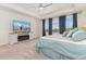 Lovely main bedroom features neighborhood views, soft carpet, and a decorative TV console for a comfy vibe at 154 Back Nine Dr, Castle Pines, CO 80108