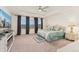 Spacious main bedroom boasts a ceiling fan and large windows with neighborhood views, a great place to unwind at 154 Back Nine Dr, Castle Pines, CO 80108