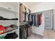 Organized walk-in closet featuring ample shelving, hanging racks, and carpet, perfect for wardrobe storage at 154 Back Nine Dr, Castle Pines, CO 80108