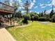 Expansive backyard featuring a lush lawn, mature trees, landscaping, deck, and an upper deck, creating a private retreat at 1744 Brookside Dr, Highlands Ranch, CO 80126