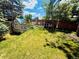 Charming backyard featuring a playhouse, chicken coop, garden, and lush lawn, ideal for outdoor enjoyment at 1744 Brookside Dr, Highlands Ranch, CO 80126