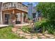 Landscaped backyard with a wooden deck, seating area, and small waterfall feature at 1744 Brookside Dr, Highlands Ranch, CO 80126